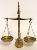 Free-standing brass set of beam scales with a turned column support and a shaped base with graduated