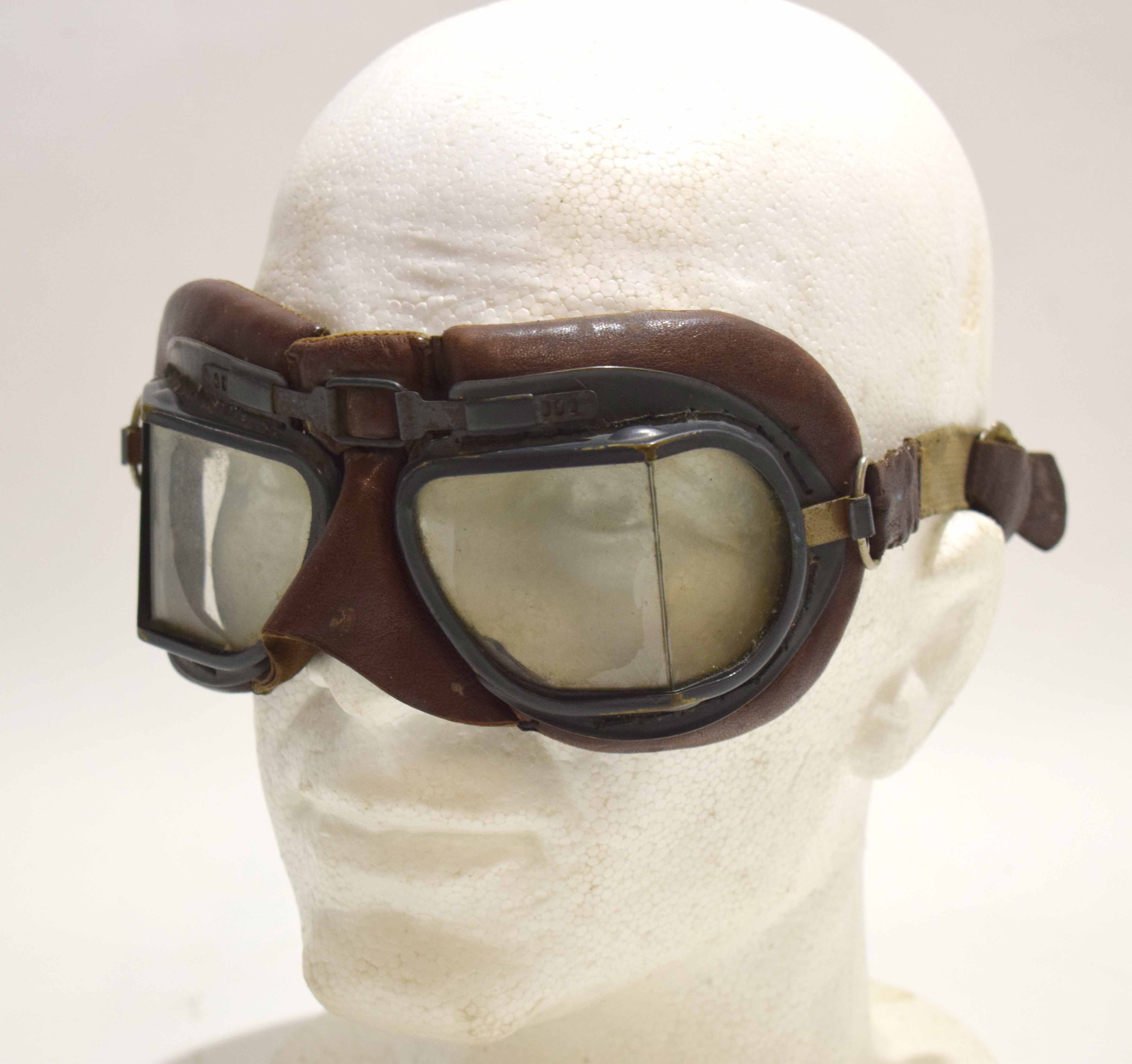 Pair of mid-20th century leather mounted goggles, the grey painted metal frames with bevelled and