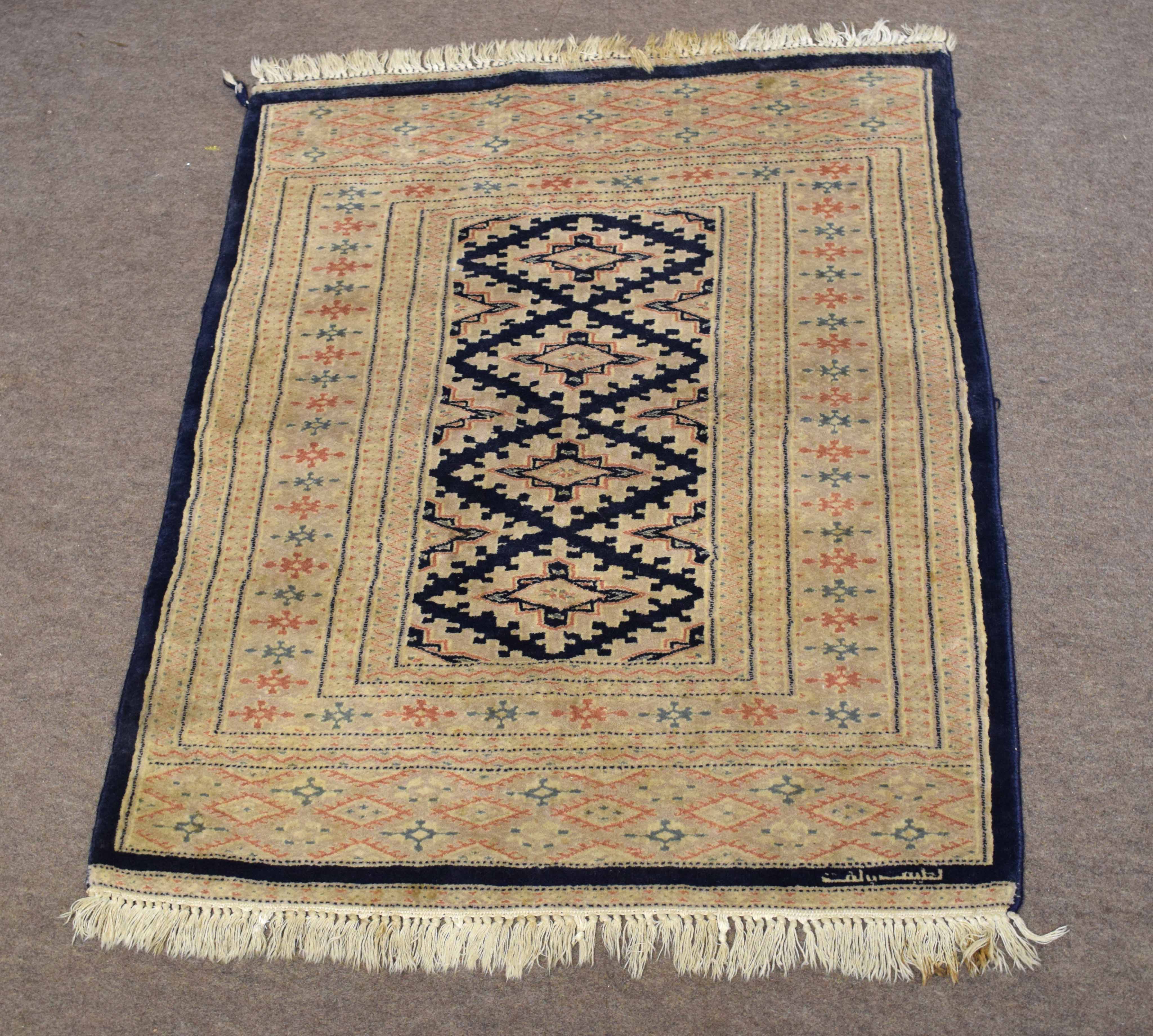Modern small prayer rug decorated predominantly in cream and blue, with repeating diamond centre