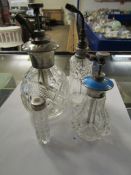 THREE SILVER TOPPED AND GLASS BASED PERFUME BOTTLES TOGETHER WITH ONE WITH ENAMELLED DETAIL (4)