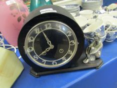 ART DECO EBONISED CIRCULAR FACED CLOCK WITH CHROMIUM SEATED FIGURE TO SIDE