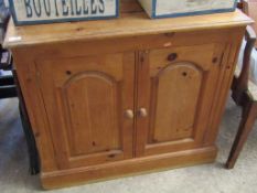 PINE FRAMED DOUBLE DOOR CUPBOARD WITH ARCHED PANEL DETAILS