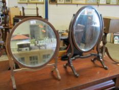 MAHOGANY FRAMED DRESSING TABLE MIRROR ON SHAPED SUPPORTS TOGETHER WITH A FURTHER SIMILAR DRESSING