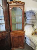 REPRODUCTION YEW WOOD FLOOR STANDING CORNER CUPBOARD WITH SINGLE GLAZED DOOR OVER PANELLED