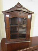 WALL MOUNTED OAK FRAMED CABINET WITH CARVED TOP