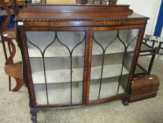 20TH CENTURY WALNUT BOW FRONTED ASTRAGAL GLAZED DISPLAY CASE RAISED ON CLAW AND BALL FEET