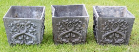 Set of three 20th century lead garden planters of tapering square form, each embossed with twining