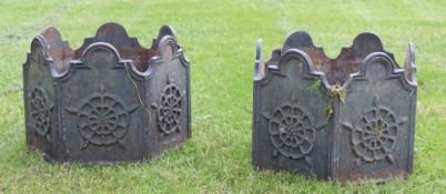 Pair of cast iron large planters of hexagonal form, each moulded with panels of geometric foliage,