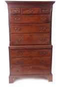 Late 18th century yew chest on chest, keyhole moulded and blind fretwork cornice over an