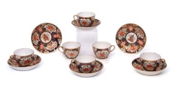 Group of six early English porcelain cups and saucers, finely decorated in an Imari style on a