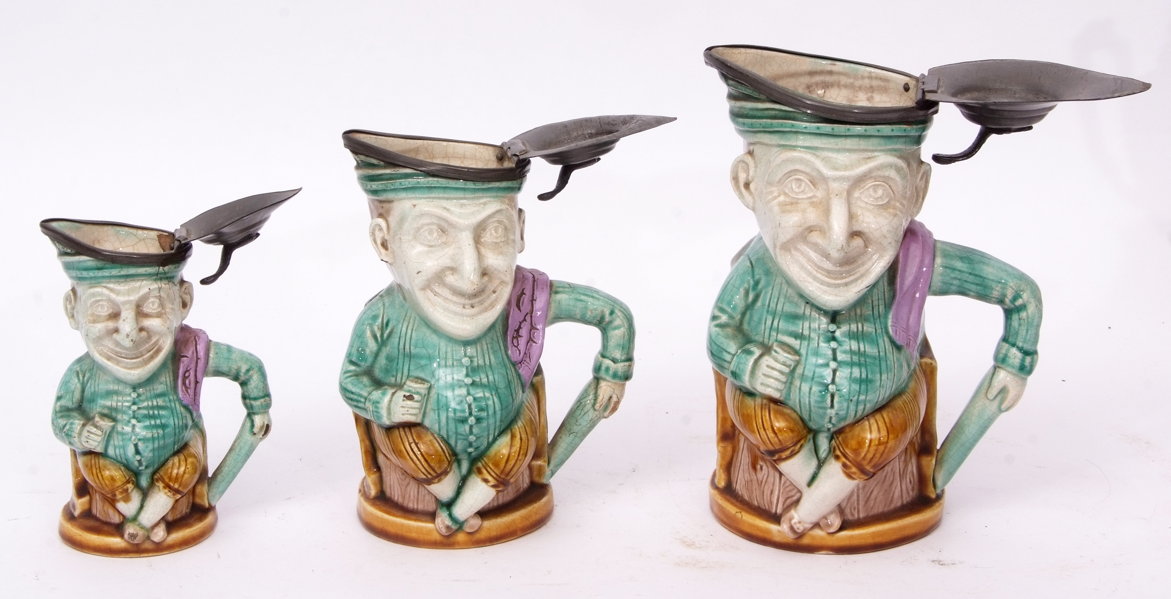 Group of late 19th century French pottery punch type jugs with pewter mounts, modelled with Majolica - Image 4 of 4