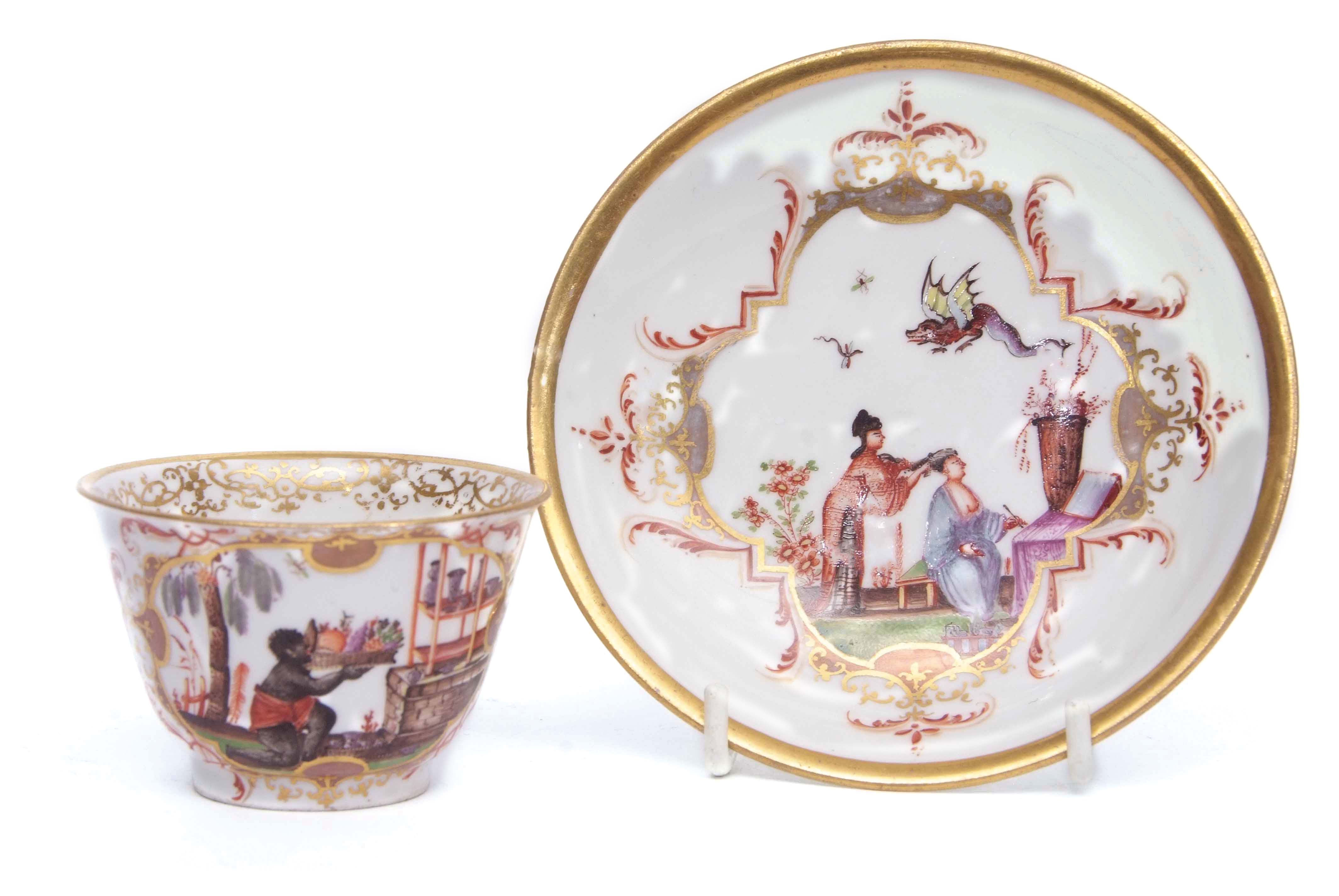 Bottger Meissen tea bowl circa 1730 with an oval cartouche of a blackamoor with a tray of fruit,