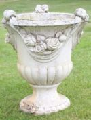 Weathered cement or composition garden urn of campana form, the circular top applied with floral