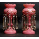 Pair of pink glass table lustres with gilded and painted floral decoration, 40cm high