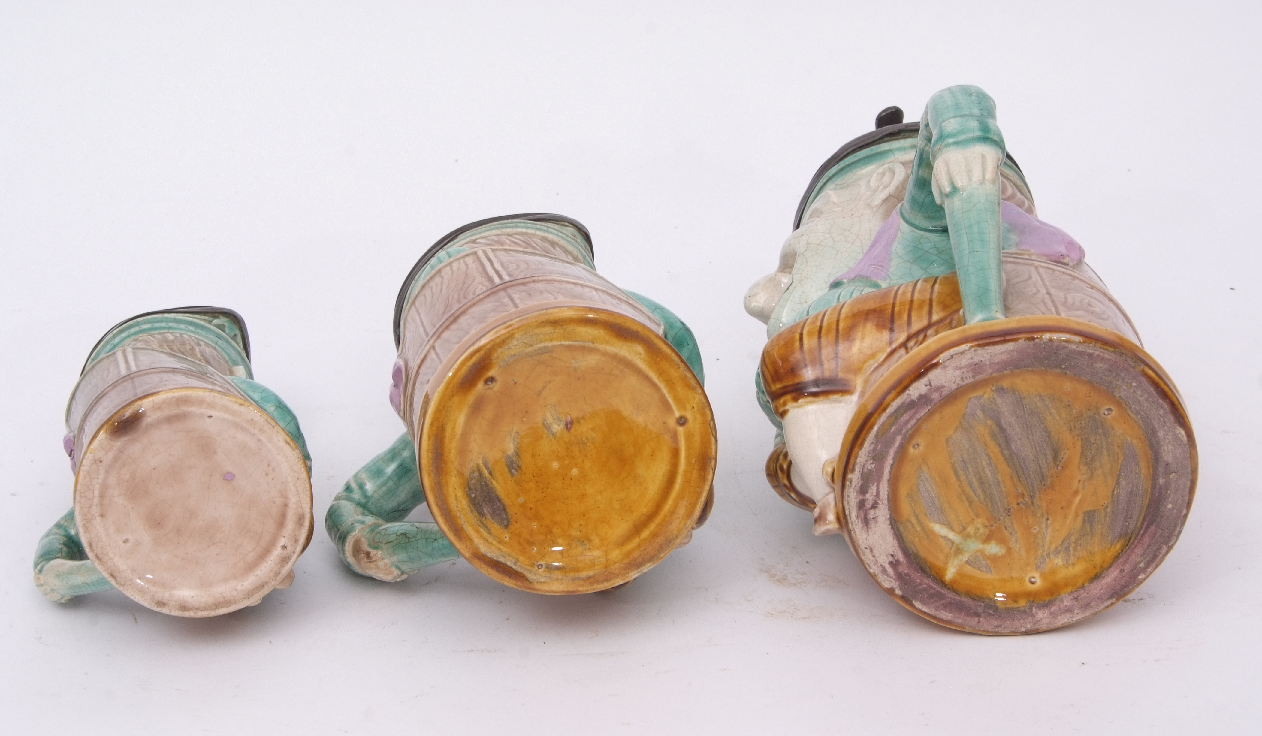 Group of late 19th century French pottery punch type jugs with pewter mounts, modelled with Majolica - Image 3 of 4