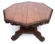 Early Victorian Gothic oak pedestal dining table of octagonal form, the rim carved with egg and dart