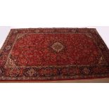 Fine modern Keshan carpet, triple-gull border, central panel of twining foliage, mainly red and blue