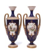 Pair of early 20th century Royal Worcester vases with gilt loop handles, the vases decorated with