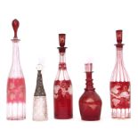 Collection of 19th century decanters, four cranberry coloured with fruiting vine design together