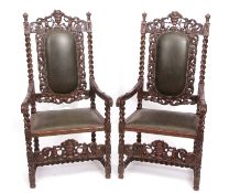 Pair of Victorian oak large carver chairs, cresting rails each carved with urn finials and putti,