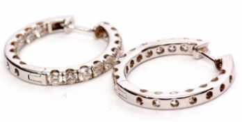Pair of diamond set hoop earrings, hinged design, each featuring 17 round brilliant cut diamonds, 10