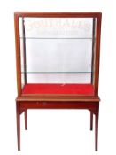 Early 20th century display/advertising cabinet, glass top, front and sides and vacant glass shelving