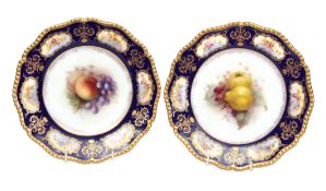 Pair of Royal Worcester plates, finely painted with fruit by Richard Seabright, the blue ground