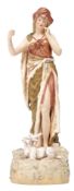 Royal Dux figure of a shepherdess standing on a rocky mound with a goat by her side, 30cm high,