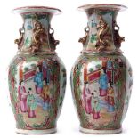 Pair of 19th century Cantonese vases with typical famille rose style decoration on a green and