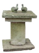 Heavy weathered stone or composition garden pedestal of square form, two-tier top on a plain