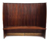 19th Century oak Tavern settle, curved form with boarded back above a solid seat flanked by panel