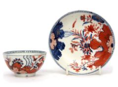 Unusual Lowestoft porcelain tea bowl and saucer with an Imari type tobacco leaf design in iron red