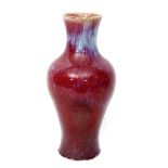 Chinese sang de boeuf vase, the baluster body with typical high fired glaze in tones of red and