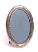 Early 20th century large Chinese oval silver mounted photograph frame, the heavy gauge oval mount