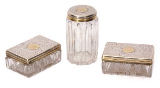 Three Victorian silver parcel gilt and clear cut glass toiletry bottles comprising two of
