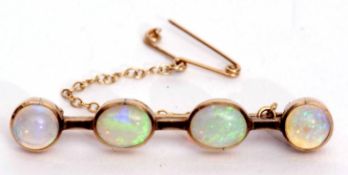 Opal bar brooch featuring two oval and two circular shaped cabochon opals, each collet set, 4.5cm