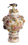 19th century Continental porcelain vase on circular base pedestal and cover with a bird knop, the