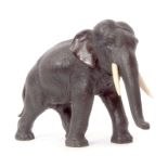 Japanese bronze model of an elephant, Meiji period, typically modelled with ivory tusks, 27cm long