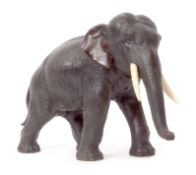 Japanese bronze model of an elephant, Meiji period, typically modelled with ivory tusks, 27cm long