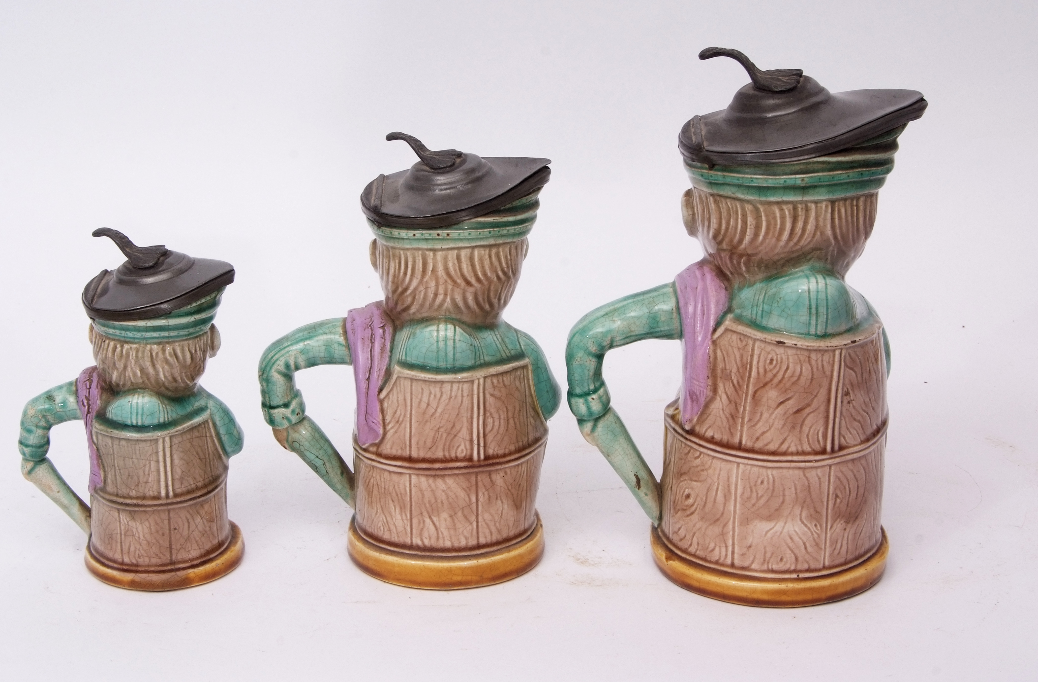 Group of late 19th century French pottery punch type jugs with pewter mounts, modelled with Majolica - Image 2 of 4