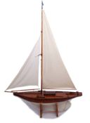 Early 20th century stained pine pond yacht, the inner cover inscribed "Restored by A D Alldred
