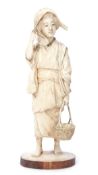 Japanese Meiji period ivory figure of a woman finely modelled, carrying a basket of bread, 19cm