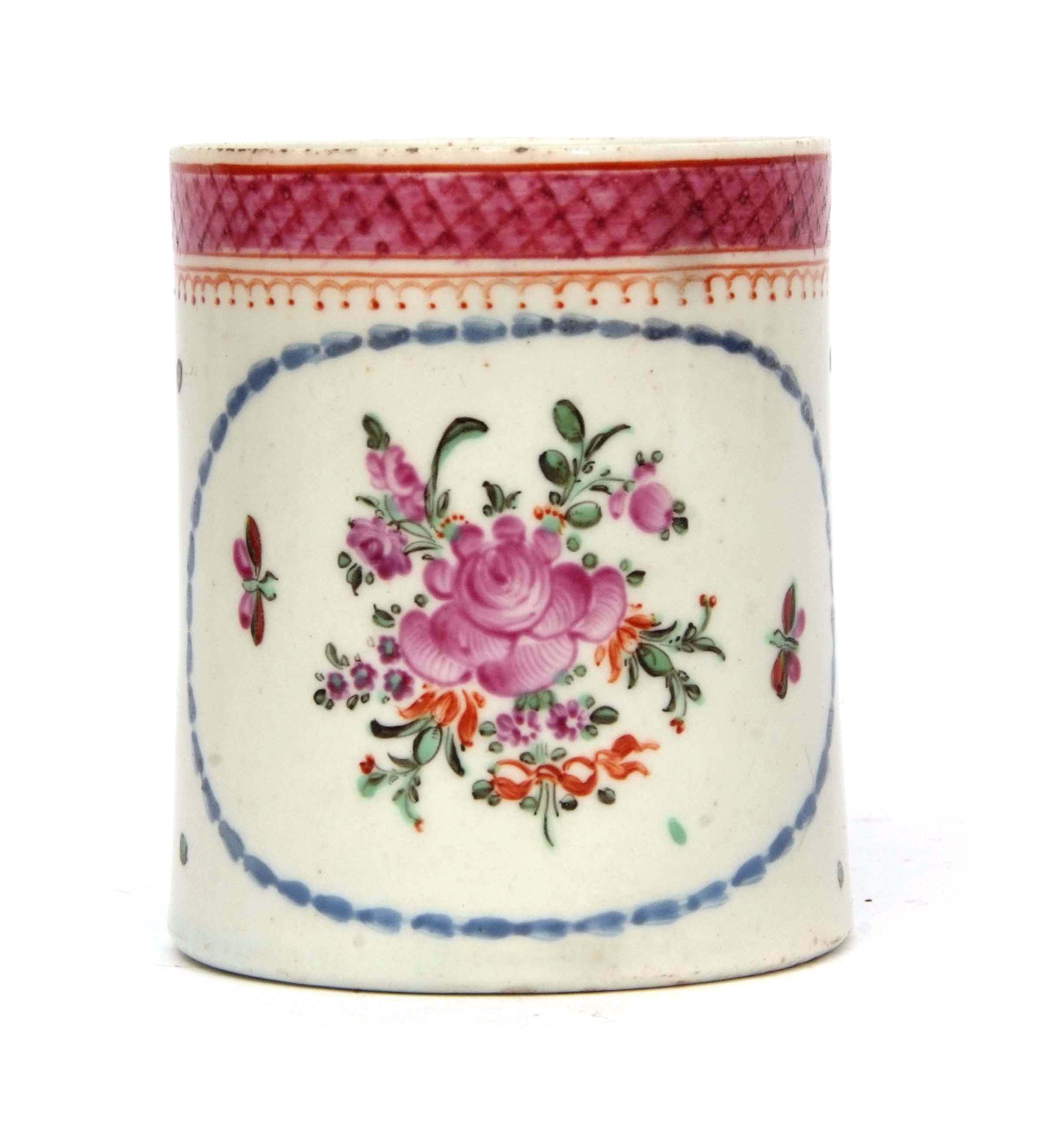 Lowestoft small polychrome mug with pip handle, the centre with a floral spray within a blue