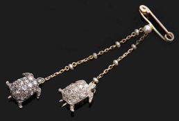 Double tortoise brooch designed as two tortoises, both set with rose cut diamonds and each suspended