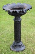 Victorian cast iron pedestal garden urn, of circular form with a crimped rim on a fluted and ring