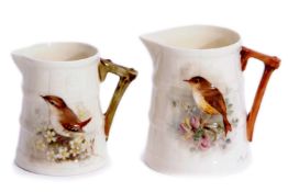 Pair of Royal Worcester jugs, painted with birds, signed by W Powell, one with a painting of a