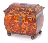 Early 19th century tortoiseshell tea caddy of sarcophagus form, the lifting lid enclosing an