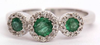 Triple emerald and diamond cluster ring featuring three graduated emeralds, 0.66ct weight approx,