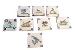 Group of 8 Delft tiles, all with polychrome decoration of birds with blue scroll borders, 14cm diam