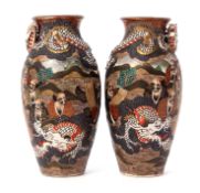 Pair of Satsuma vases decorated in relief with immortals and a dragon encircling the neck of the